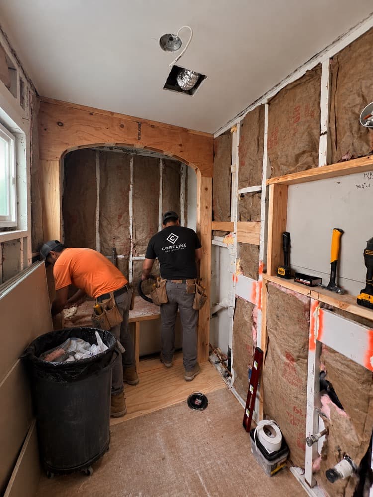 Two Coreline crew members framing a bathroom remodel